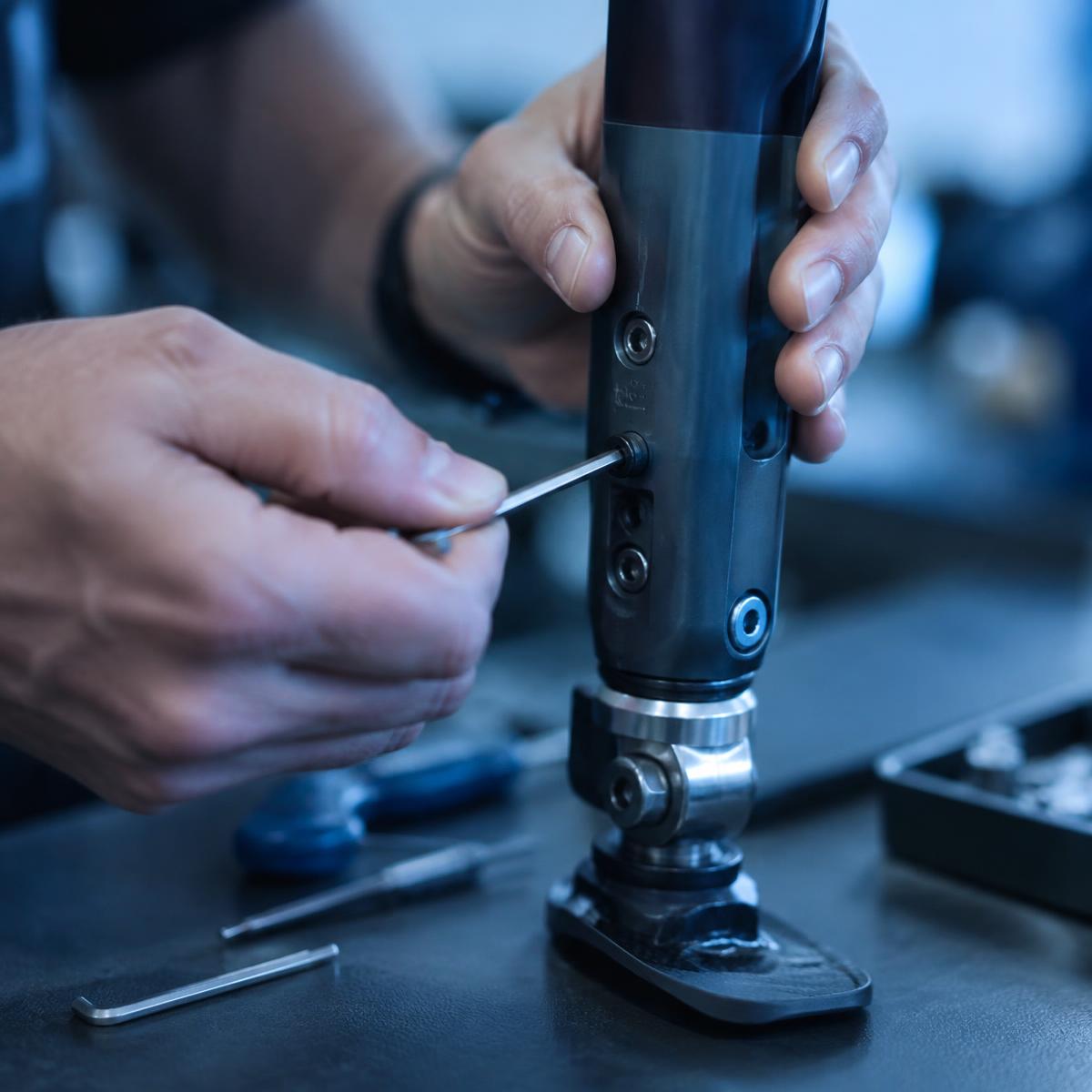 Hands adjusting the alignment of a lower-limb prosthesis